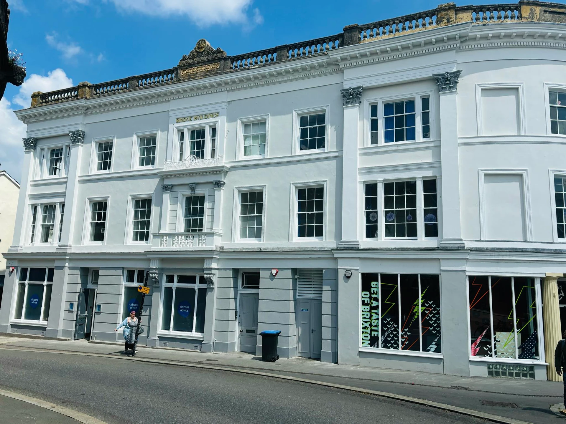 Side view of Bridge Buildings showing the curved white facade with ornate details