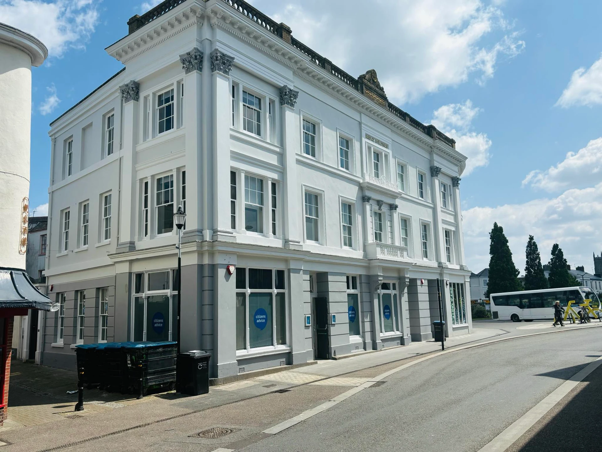 Full view of Bridge Buildings with freshly painted white upper floors and gray ground floor