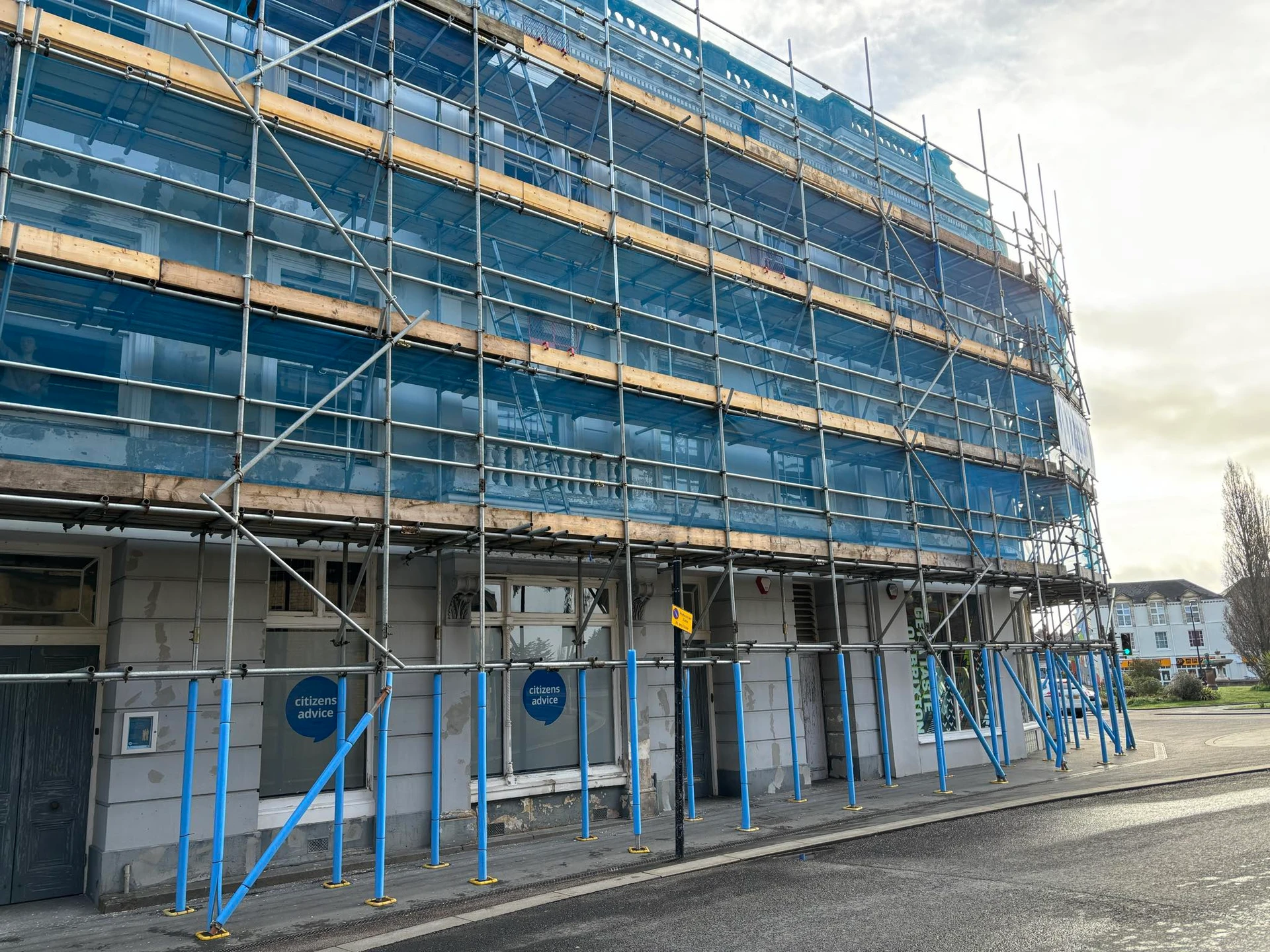 Extensive scaffolding with blue protective sheeting covering the Bridge Buildings during renovation