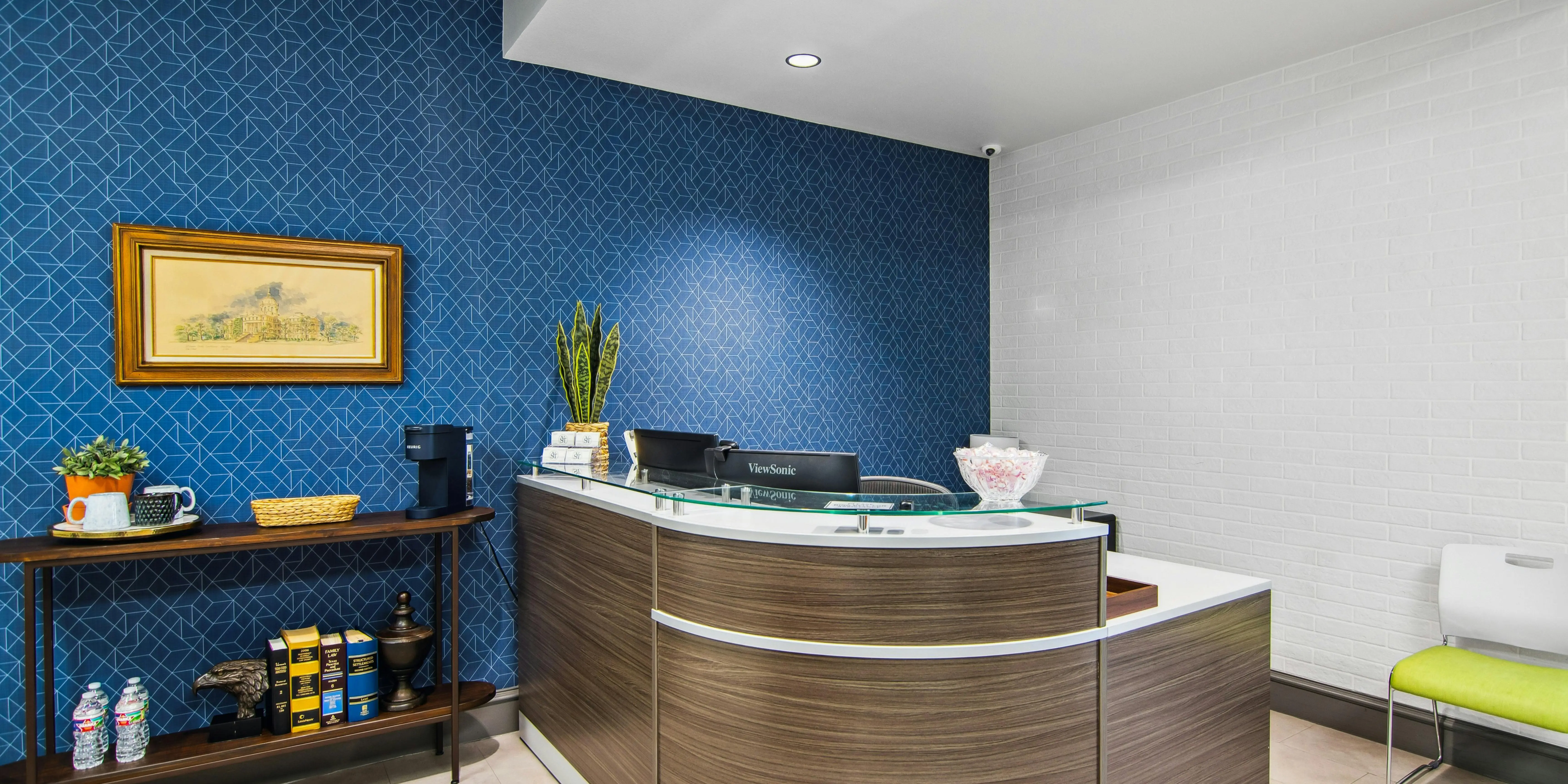 Modern office reception with blue geometric wallpaper