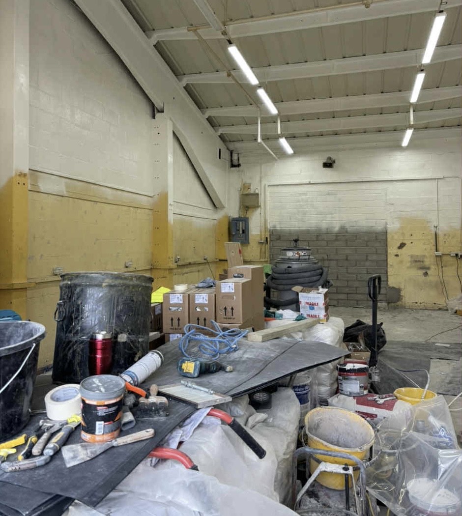 Parker Hannifin industrial space before painting with yellow protective boards and painting supplies