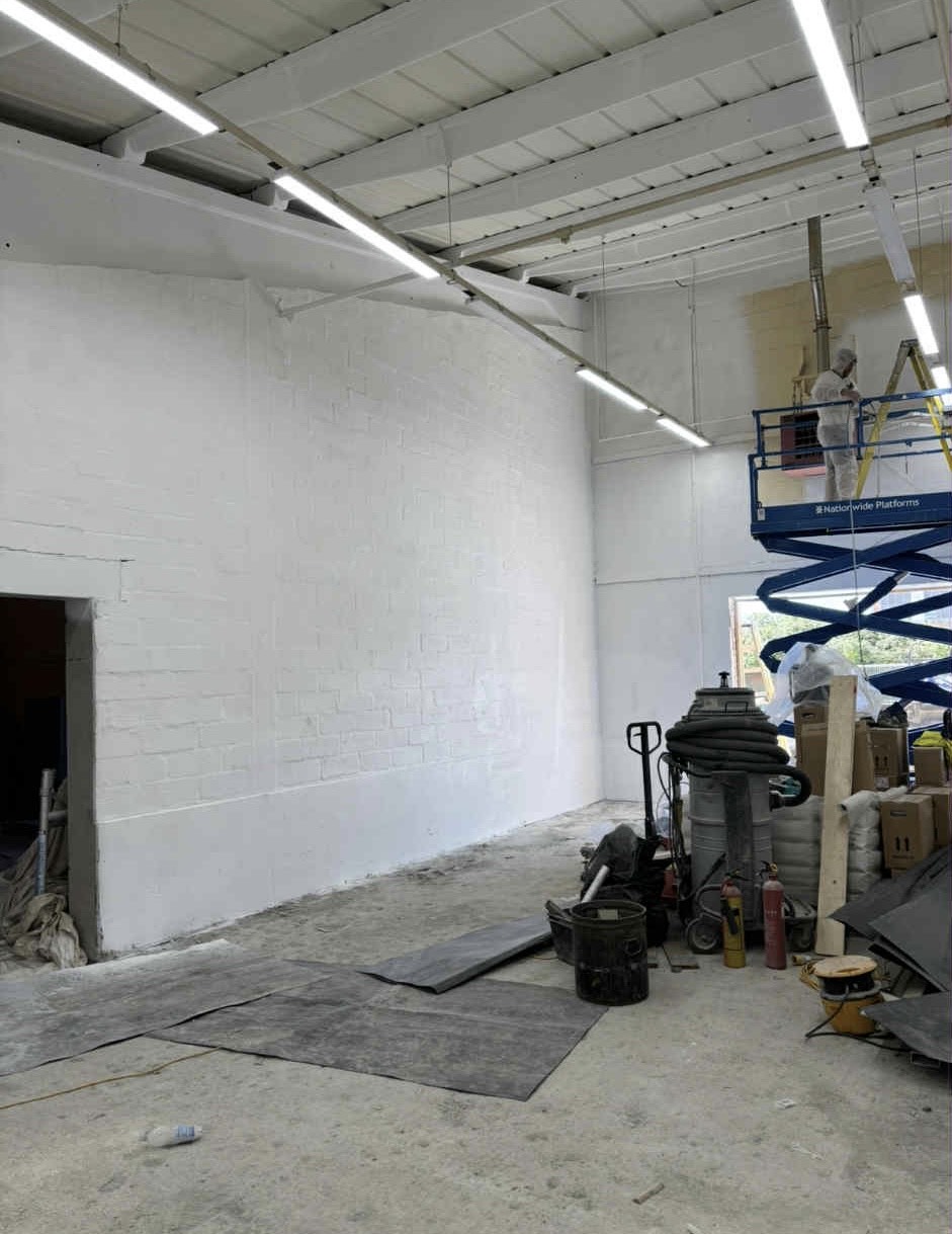 Completed white painted walls in industrial space at Parker Hannifin