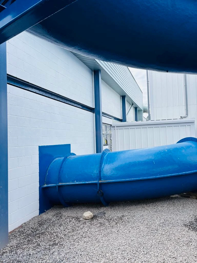 Completed white walls with blue trim and water slide at Ruda Holiday Park