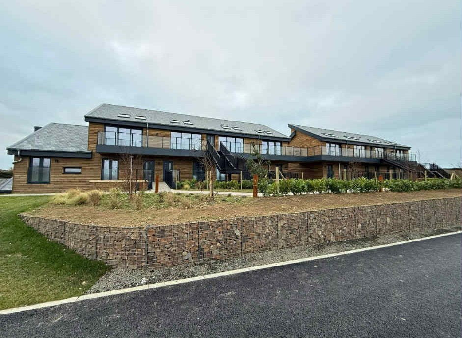 Completed modern wooden apartment buildings at Widemouth Bay, Bude with landscaped grounds